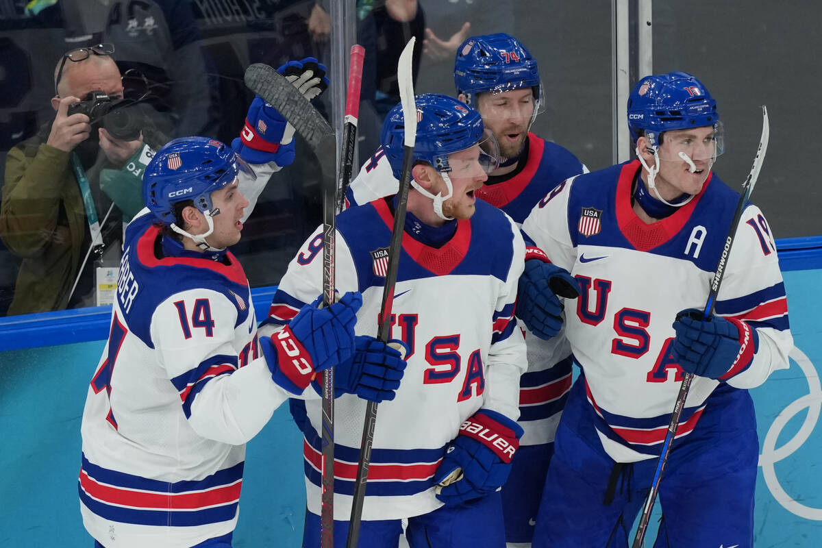 United States' Jack Eichel (9) celebrates with Brock Faber (14), Jaccob Slavin (74) and Ma ...