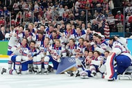 Gold medalists United States celebrate after defeating Canada in a men's ice hockey gold...