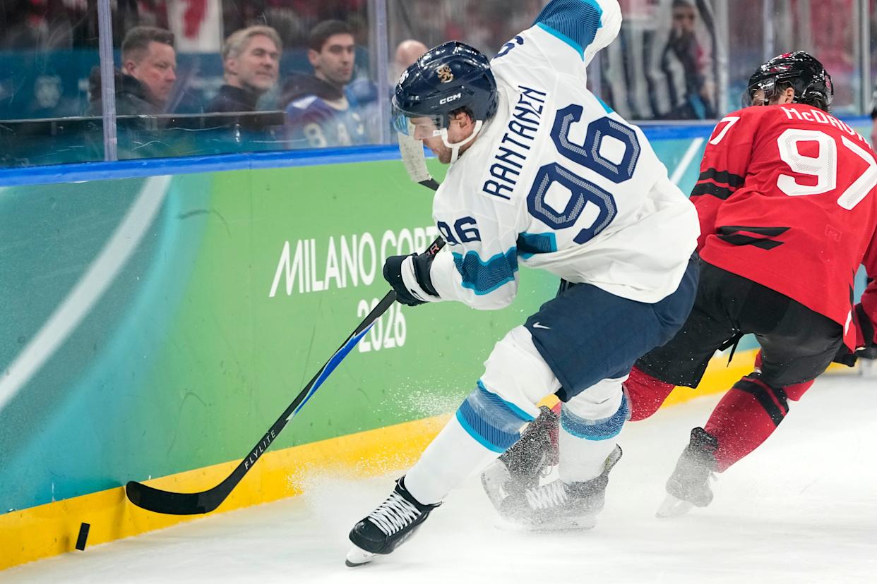 Finland's Mikko Rantanen (96) challenges with Canada's Connor McDavid (97) during a men's ice hockey semifinal game between Canada and Finland at the 2026 Winter Olympics, in Milan, Italy, Friday, Feb. 20, 2026. (AP Photo/Hassan Ammar)
