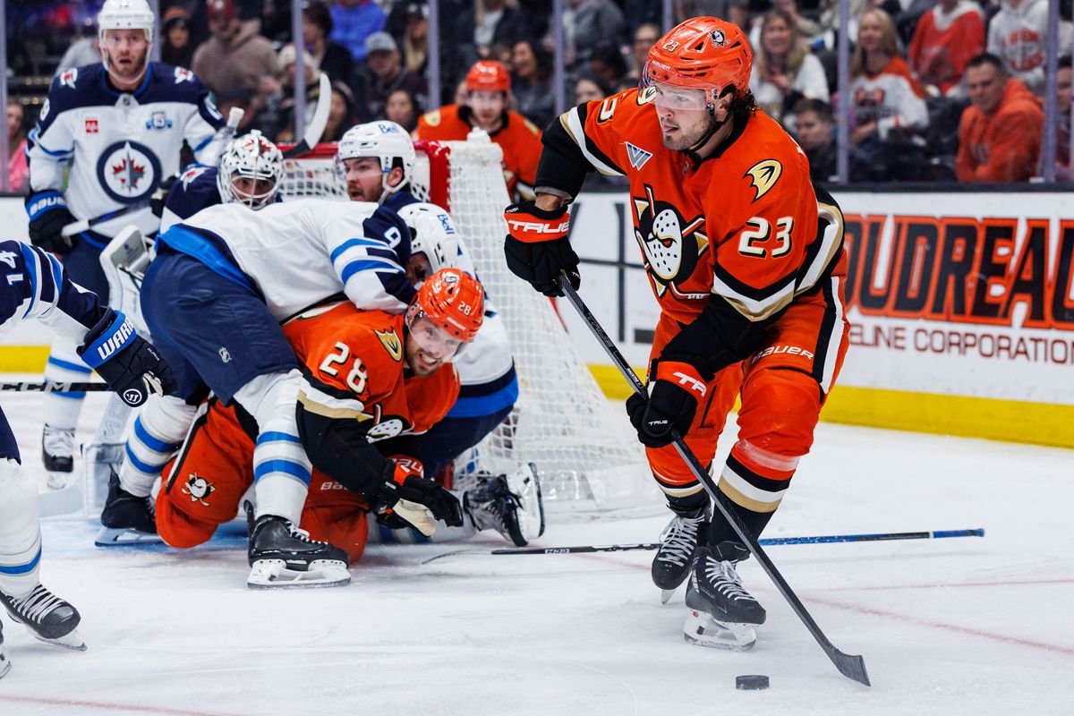 Anaheim Ducks center Mason McTavish (23) secures the puck during an NHL match against the Winnipeg Jets on February 27, 2026 in Anaheim, California.