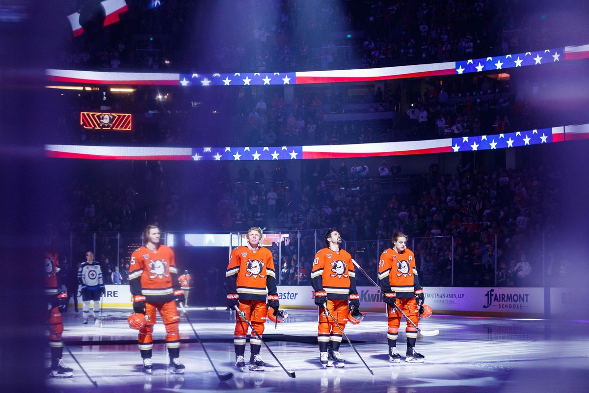 Anaheim Ducks players stand during the national anthem before an NHL match against the Winnipeg Jets on February 27, 2026 in Anaheim, California.