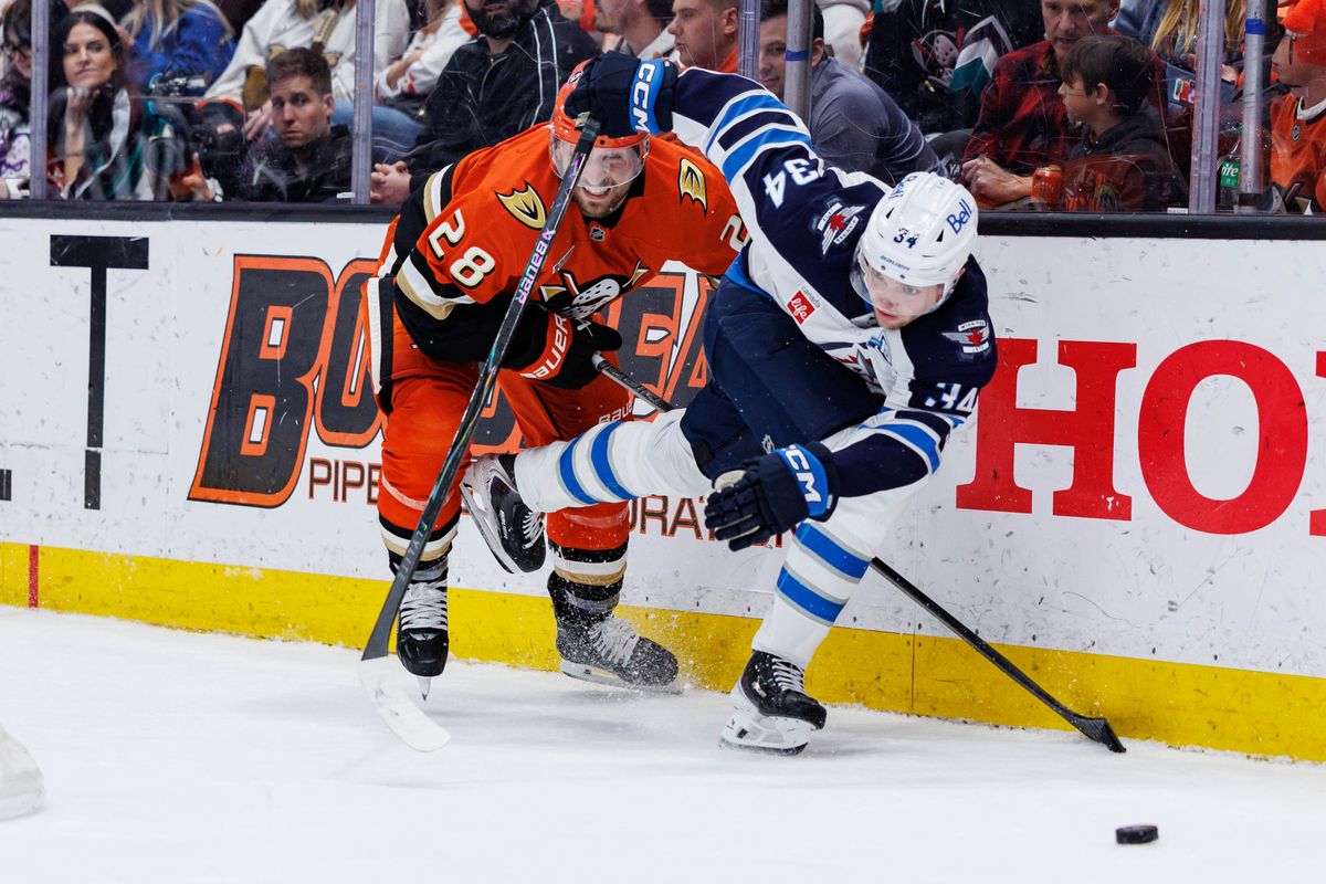 Winnipeg Jets defenseman Ville Heinola (34) defends the puck during an NHL match against the Anaheim Ducks on February 27, 2026 in Anaheim, California.