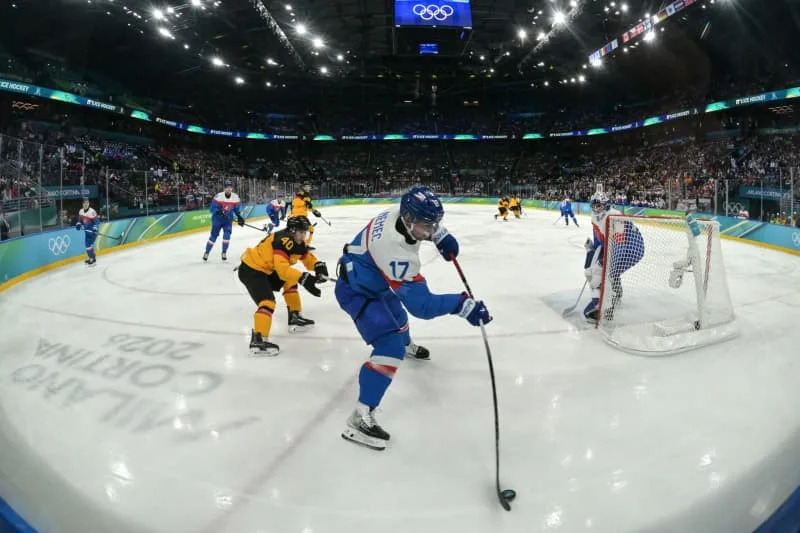 Germany's Alexander Ehl challenges Slovakia's Libor Hudacek during the men's play-offs quater final Ice hockey match between Slovakia and Germany, as part of the 2026 Winter Olympic Games in Milan-Cortina. Peter Kneffel/dpa