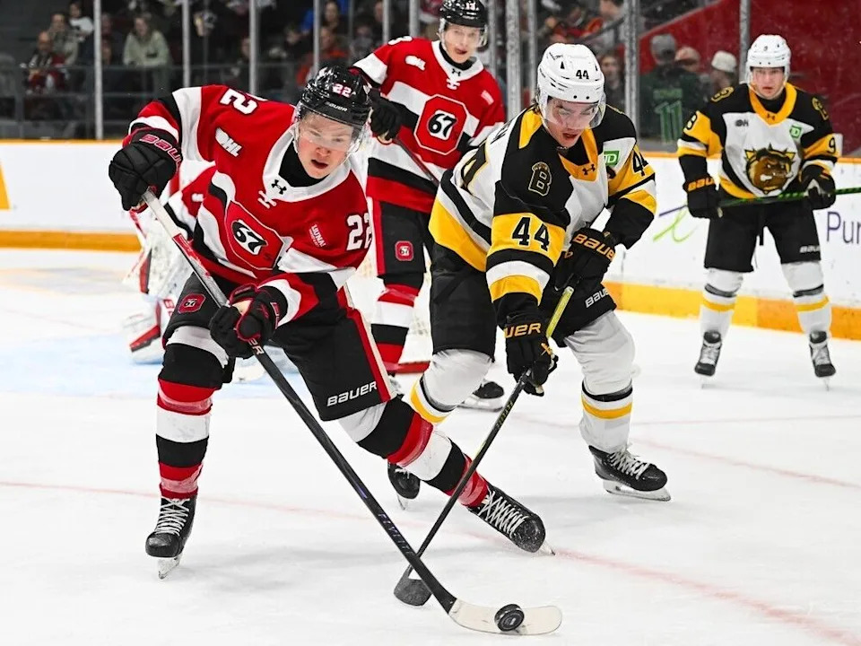  Ottawa 67’s Jasper Kuhta (22, left) and Brantford Bulldogs’ Jake O’Brien (44) battle for possession of the puck during Saturday’s game at TD Place.