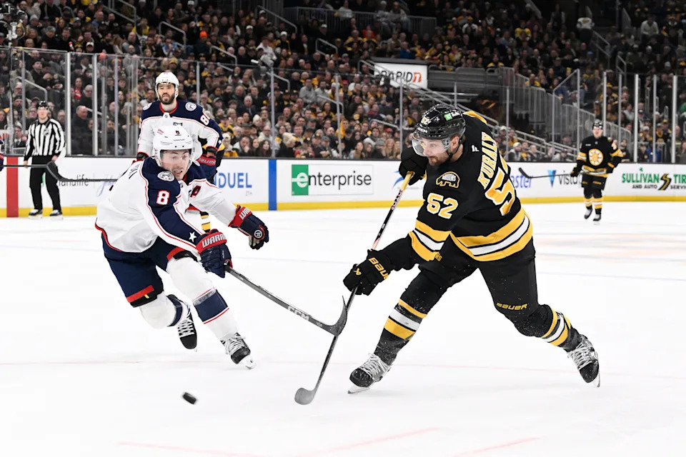 Feb 26, 2026; Boston, Massachusetts, USA; Boston Bruins center Sean Kuraly (52) scores a goal against Columbus Blue Jackets defenseman Zach Werenski (8) during the third period at TD Garden. Mandatory Credit: Eric Canha-Imagn Images