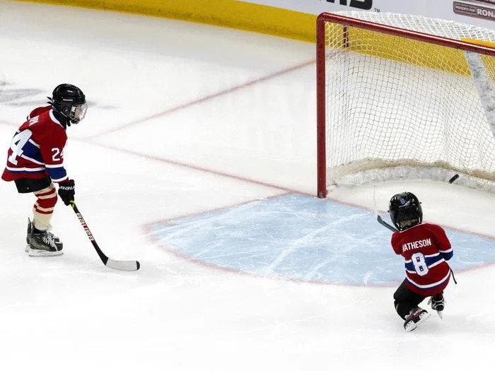  Phillip-Édouard Danault, left, and Hudson Matheson take shots on the net as their fathers compete in the Montreal Canadiens’ skills competition at the Bell Centre on Sunday, February 22, 2026.