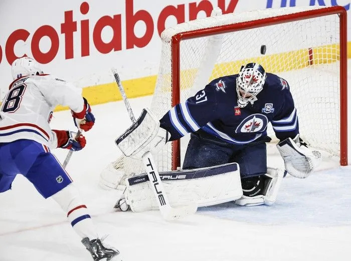  Montreal Canadiens’ Lane Hutson scores on Winnipeg Jets goaltender Connor Hellebuyck during the second period at Canada Life Centre on February 4, 2026.