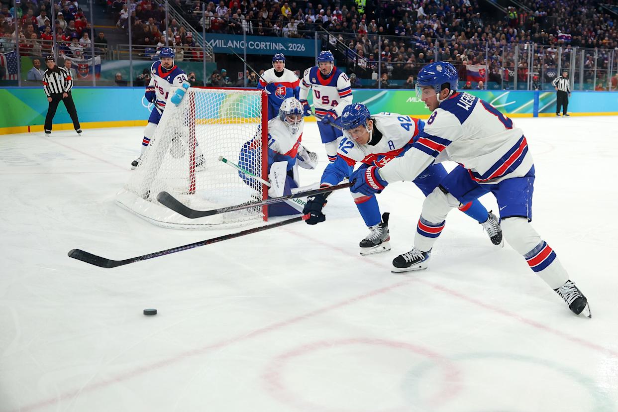 MILAN, ITALY - FEBRUARY 20: Martin Fehervary #42 of Team Slovakia and Zach Werenski #8 of Team United States compete for the puck in the second period during the Men's Semifinals Playoff match between the United States and Slovakia on day fourteen of the Milano Cortina 2026 Winter Olympic games at Milano Santagiulia Ice Hockey Arena on February 20, 2026 in Milan, Italy. (Photo by Gregory Shamus/Getty Images)