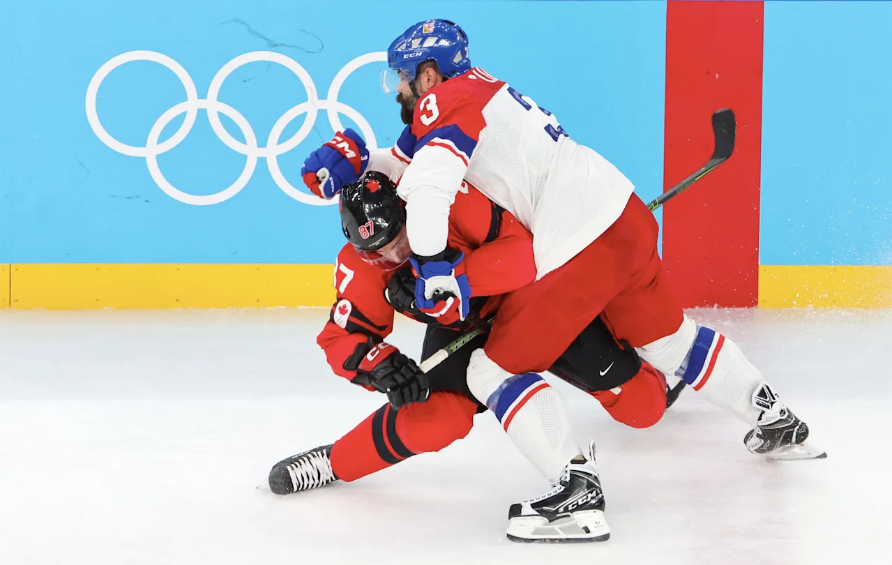 MILAN, ITALY - FEBRUARY 18: Captain, Sidney Crosby #87 of Team Canada injures himself as result of the charge of Radko Dugas #3 of Team Czech during the Ice Hockey Men's Play-off Quarterfinals match between Team Canada and Team Czech Republic on day twelve of the Milano Cortina 2026 Winter Olympic games at Milano Santagiulia Ice Hockey Arena on February 18, 2026 in Milan, Italy. (Photo by Xavier Laine/Getty Images)