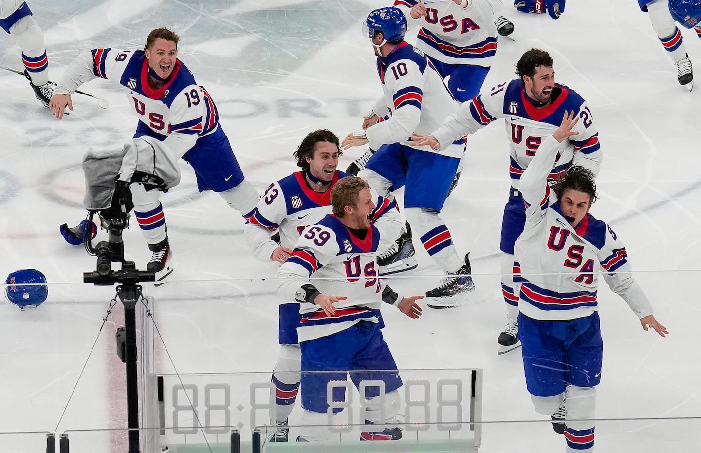 Jack Hughes (far right), celebrates with his US teammates after scoring the game winning goal.