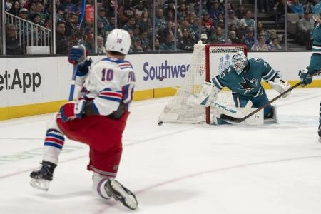 Jan 23, 2026; San Jose, California, USA; San Jose Sharks goaltender Alex Nedeljkovic (33) defends the goal during the first period against New York Rangers left wing Artemi Panarin (10) at SAP Center at San Jose. Mandatory Credit: Stan Szeto-Imagn Images