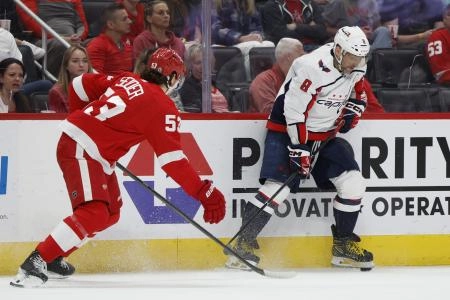 Apr 9, 2024; Detroit, Michigan, USA; Washington Capitals left wing Alex Ovechkin (8) skates with the puck defended by Detroit Red Wings defenseman Moritz Seider (53) in the third period at Little Caesars Arena.