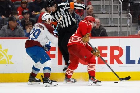 Jan 31, 2026; Detroit, Michigan, USA; Detroit Red Wings center Dylan Larkin (71) skates against Colorado Avalanche center Nathan MacKinnon (29) in the second period at Little Caesars Arena. Mandatory Credit: Rick Osentoski-Imagn Images