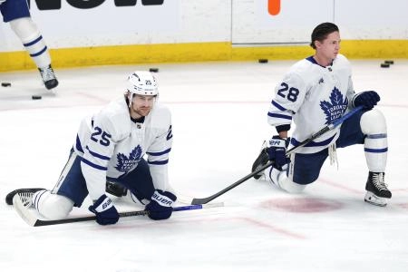 Jan 17, 2026; Winnipeg, Manitoba, CAN; Toronto Maple Leafs defenseman Brandon Carlo (25) and Toronto Maple Leafs defenseman Troy Stecher (28) warm up before a game against the Winnipeg Jets at Canada Life Centre. Mandatory Credit: James Carey Lauder-Imagn Images