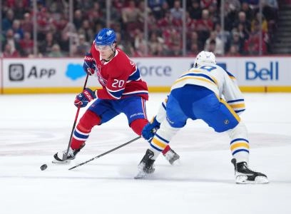 Jan 22, 2026; Montreal, Quebec, CAN; Montreal Canadiens forward Juraj Slafkovsky (20) plays the puck and Buffalo Sabres forward Alex Tuch (89) defends during the first period at the Bell Centre.