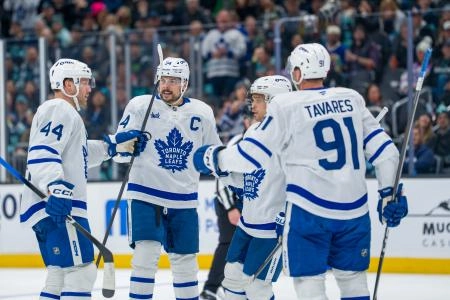 Jan 29, 2026; Seattle, Washington, USA; Toronto Maple Leafs, from left, defenseman Morgan Rielly (44), forward Auston Matthews (34), forward Max Domi (11) and forward John Tavares (91) celebrate a goal during the third period at Climate Pledge Arena. Mandatory Credit: Stephen Brashear-Imagn Images