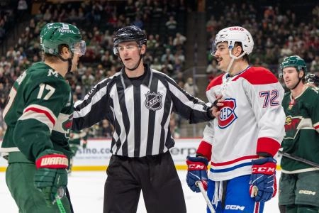 Nov 14, 2024; Saint Paul, Minnesota, USA; linesman Kyle Flemington (55) breaks up Minnesota Wild left wing Marcus Foligno (17) and Montreal Canadiens defenseman Arber Xhekaj (72) during an altercation in the third period at Xcel Energy Center.