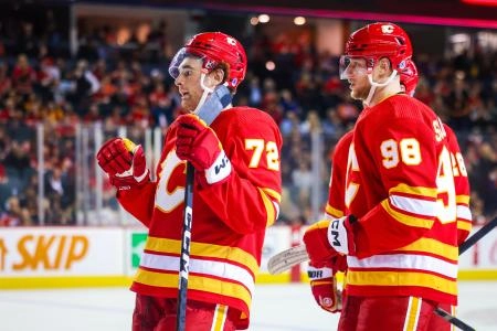 Sep 29, 2023; Calgary, Alberta, CAN; Calgary Flames defenseman Jeremie Poirier (72) celebrates his goal with teammates against the Edmonton Oilers during the second period at Scotiabank Saddledome.