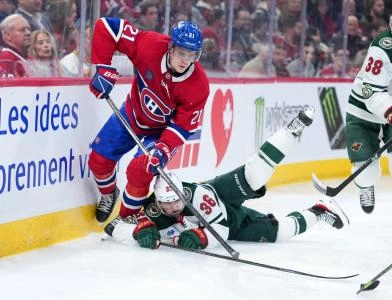 Jan 20, 2026; Montreal, Quebec, CAN; Montreal Canadiens defenseman Kaiden Guhle (21) takes the puck away from Minnesota Wild forward Mats Zuccarello (36) during the third period at the Bell Centre.