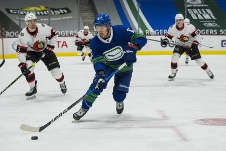 Apr 22, 2021; Vancouver, British Columbia, CAN; Vancouver Canucks forward Jayce Hawryluk (13) handles the puck against the Ottawa Senators in the third period at Rogers Arena.