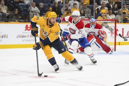 Apr 6, 2025; Nashville, Tennessee, USA; Nashville Predators center Ryan O'Reilly (90) skates with the puck against the Montreal Canadiens during the second period at Bridgestone Arena.