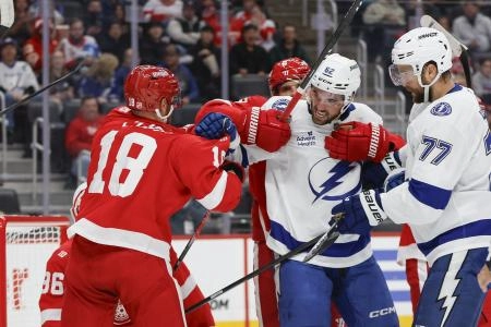 Oct 17, 2025; Detroit, Michigan, USA; Detroit Red Wings center Andrew Copp (18) scuffles with Tampa Bay Lightning center Jack Finley (62) in front of the net during the first period at Little Caesars Arena. Mandatory Credit: Brian Bradshaw Sevald-Imagn Images