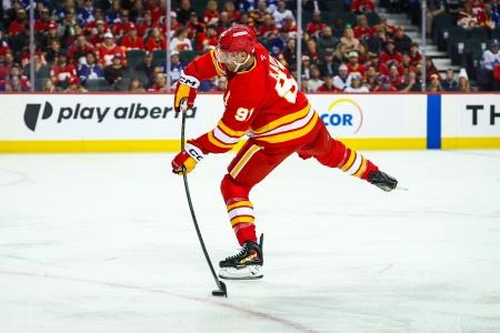 Feb 2, 2026; Calgary, Alberta, CAN; Calgary Flames center Nazem Kadri (91) shoots the puck against the Toronto Maple Leafs during the second period at Scotiabank Saddledome.