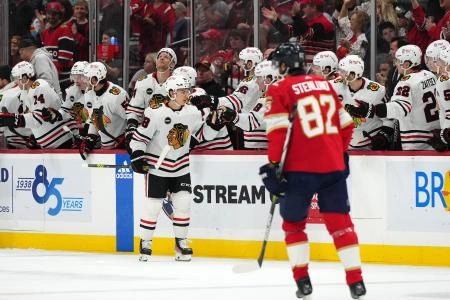 Nov 12, 2023; Sunrise, Florida, USA; Chicago Blackhawks center Connor Bedard (98) celebrates his goal against the Florida Panthers with teammates on the bench during the second period at Amerant Bank Arena.