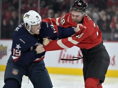 Team United States forward Matthew Tkachuk (19) and Team Canada forward brandon Hagel (38) fight in the first period during a 4 Nations Face-Off ice hockey game at the Bell Centre.