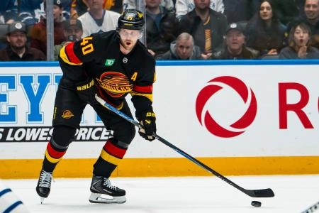 Jan 31, 2026; Vancouver, British Columbia, CAN; Vancouver Canucks forward Elias Pettersson (40) handles the puck against the Toronto Maple Leafs in overtime at Rogers Arena.