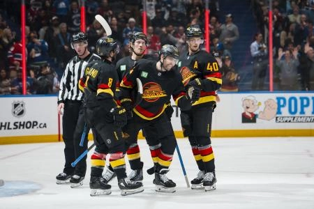 Oct 25, 2025; Vancouver, British Columbia, CAN; Vancouver Canucks forward Conor Garland (8) and forward Jake DeBrusk (74) and forward Brock Boeser (6) and forward Elias Pettersson (40) celebrate DeBrusk#8217;s goal against the Montreal Canadiens in the second period at Rogers Arena.
