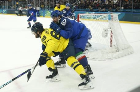 Feb 11, 2026; Milan, Italy; William Nylander of Sweden in action with Mats Frycklund of Italy in men's ice hockey group B play during the Milano Cortina 2026 Olympic Winter Games at Milano Santagiulia Ice Hockey Arena. Mandatory Credit: Geoff Burke-Imagn Images