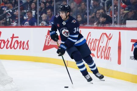 Sep 23, 2025; Winnipeg, Manitoba, CAN; Winnipeg Jets defenseman Ville Heinola (34) looks to make a pass against the Edmonton Oilers during the first period at Canada Life Centre.