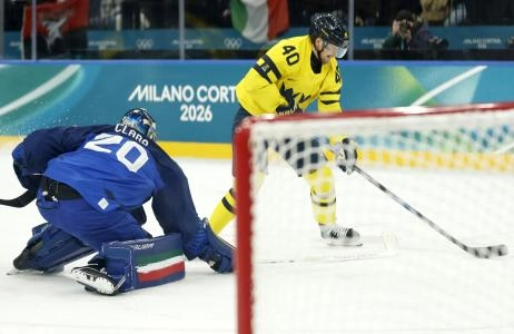 Feb 11, 2026; Milan, Italy; Elias Pettersson of Sweden in action with Damian Clara of Italy in men's ice hockey group B play during the Milano Cortina 2026 Olympic Winter Games at Milano Santagiulia Ice Hockey Arena.