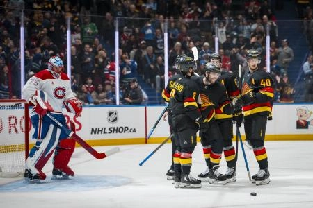 Oct 25, 2025; Vancouver, British Columbia, CAN; Montreal Canadiens goalie Jakub Dobes (75) watches as Vancouver Canucks forward Conor Garland (8) and forward Jake DeBrusk (74) and forward Brock Boeser (6) and forward Elias Pettersson (40) celebrate DeBrusk's goal in the second period at Rogers Arena.