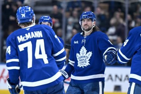 Dec 23, 2025; Toronto, Ontario, CAN; Toronto Maple Leafs defenseman Chris Tanev (8) greets forward Bobby McMann who scored an empty net goal against the Pittsburgh Penguins in the third period at Scotiabank Arena. Mandatory Credit: Dan Hamilton-Imagn Images