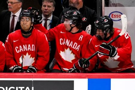 Jan 5, 2026; St. Paul, Minnesota, USA; Canada defensemen Harrison Brunicke (4) congratulates defensemen Zayne Parekh (19) on his power play goal against Finland as defensemen Keaton Verhoeff (20) looks on during the first period in the third place game of the 2026 IIHF World Junior Championship ice hockey tournament at Grand Casino Arena.