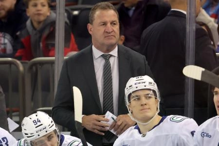 Dec 16, 2025; New York, New York, USA; Vancouver Canucks head coach Adam Foote coaches against the New York Rangers during the first period at Madison Square Garden.