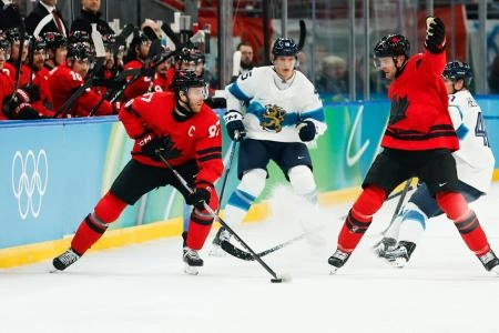 Feb 20, 2026; Milan, Italy; Connor McDavid (97) of Canada looks to pass during the second period against Finland in a men's ice hockey semifinal during the Milano Cortina 2026 Olympic Winter Games at Milano Santagiulia Ice Hockey Arena. Mandatory Credit: Geoff Burke-Imagn Images