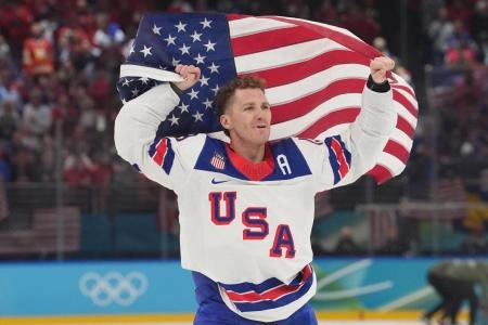 Feb 22, 2026; Milan, Italy; Matthew Tkachuk (19) of the United States celebrates after defeating Canada in the men's ice hockey gold medal game during the Milano Cortina 2026 Olympic Winter Games at Milano Santagiulia Ice Hockey Arena. Mandatory Credit: Amber Searls-Imagn Images