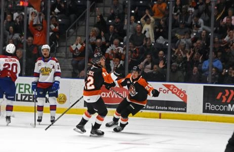 Liam Ruck and Markus Ruck celebrate a goal for the WHL's Medicine Hat Tigers.