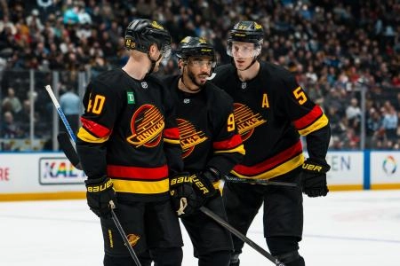 Jan 21, 2026; Vancouver, British Columbia, CAN; Vancouver Canucks forward Elias Pettersson (40) and forward Evander Kane (91) and defenseman Tyler Myers (57) during a stop in play against the Washington Capitals in the second period at Rogers Arena.