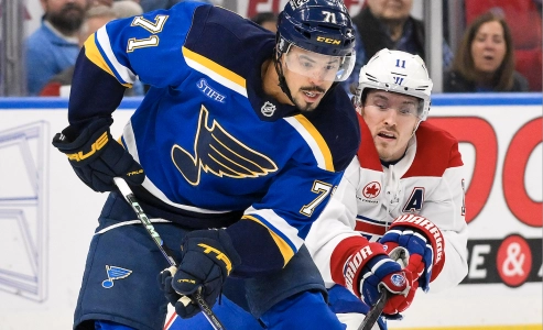 Mar 25, 2025; St. Louis, Missouri, USA; St. Louis Blues right wing Mathieu Joseph (71) controls the puck as Montreal Canadiens right wing Brendan Gallagher (11) defends during the second period at Enterprise Center.