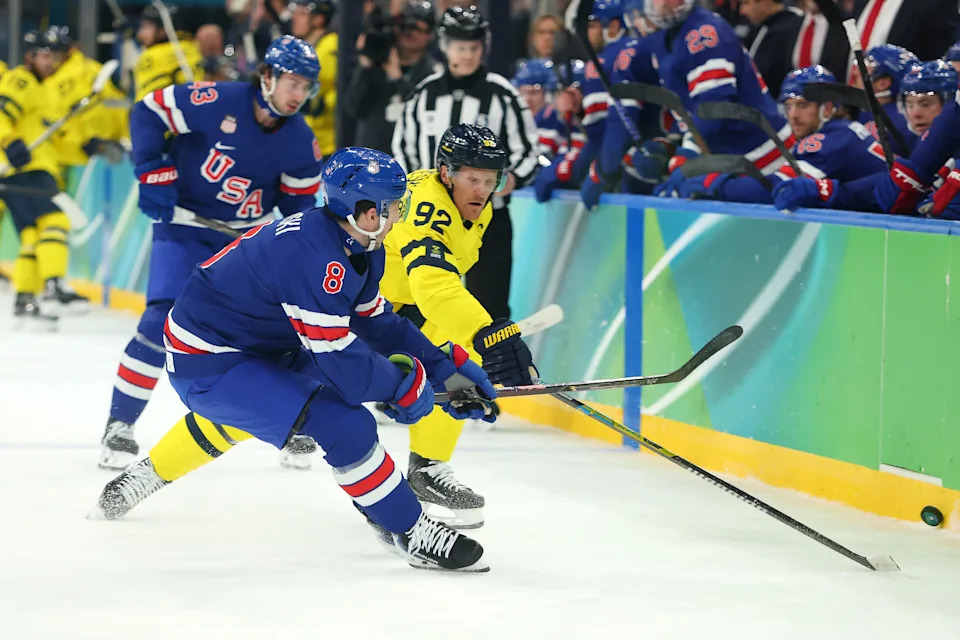 MILAN, ITALY - FEBRUARY 18: Zach Werenski #8 of Team United States and Gabriel Landeskog #92 of Team Sweden compete for the puck in the first period during the Men's Quarterfinals Playoff match between the United States and Sweden on day 12 of the Milano Cortina 2026 Winter Olympic games at Milano Santagiulia Ice Hockey Arena on February 18, 2026 in Milan, Italy. (Photo by Gregory Shamus/Getty Images)