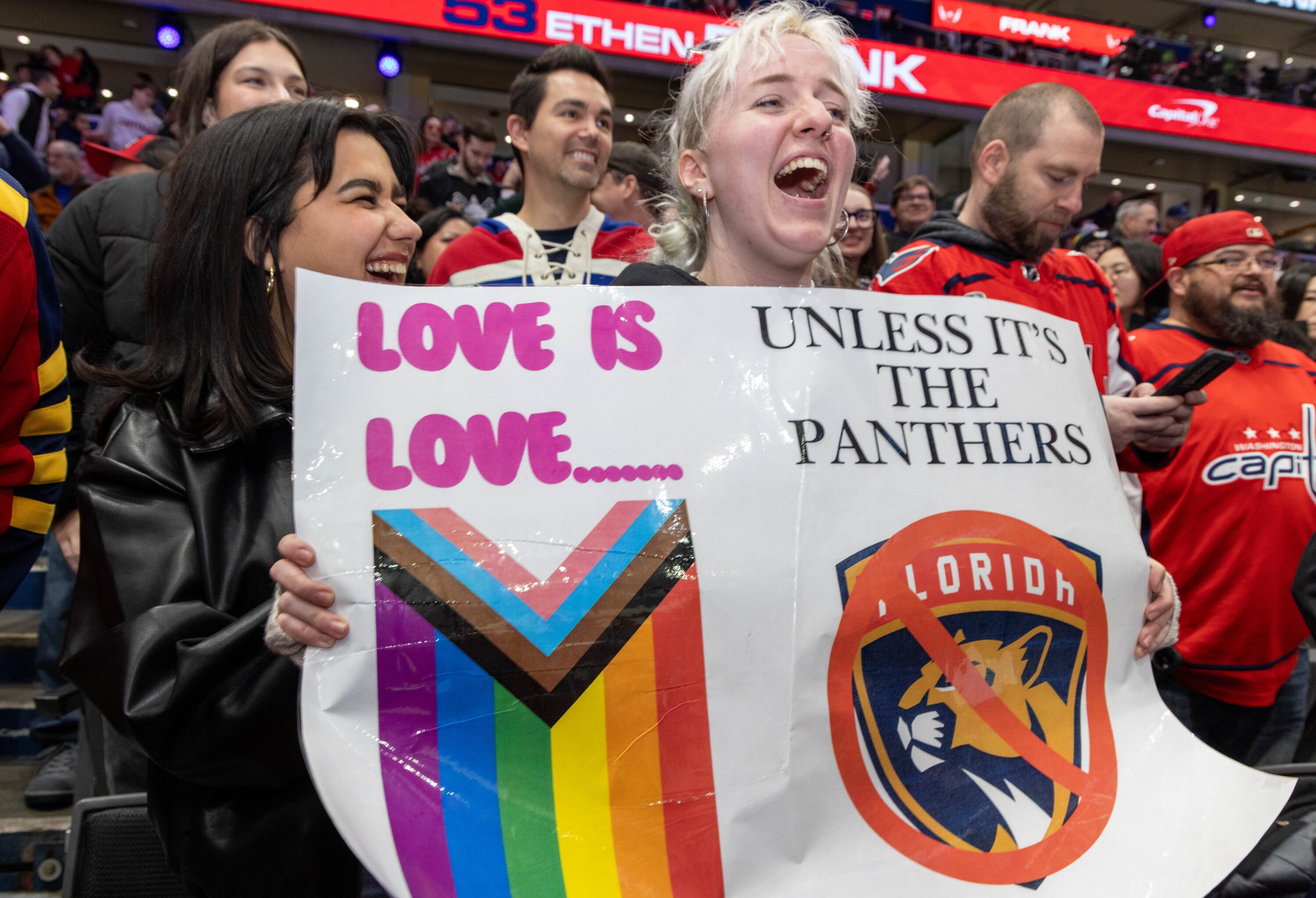 Capitals fans hold a Pride-themed sign during the game. Photo courtesy of Evy Mages.