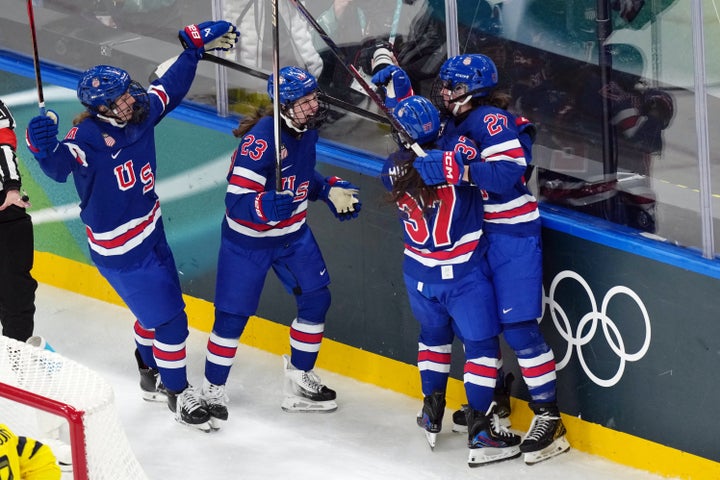 Team USA's Taylor Heise (right) celebrates with her teammates following her goal against Sweden in the second period of Monday's semifinal match in Milan.