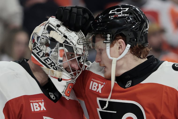 Flyers goalie Dan Vladar (left) and Owen Tippett celebrate after Tuesday's win over the Washington Capitals.