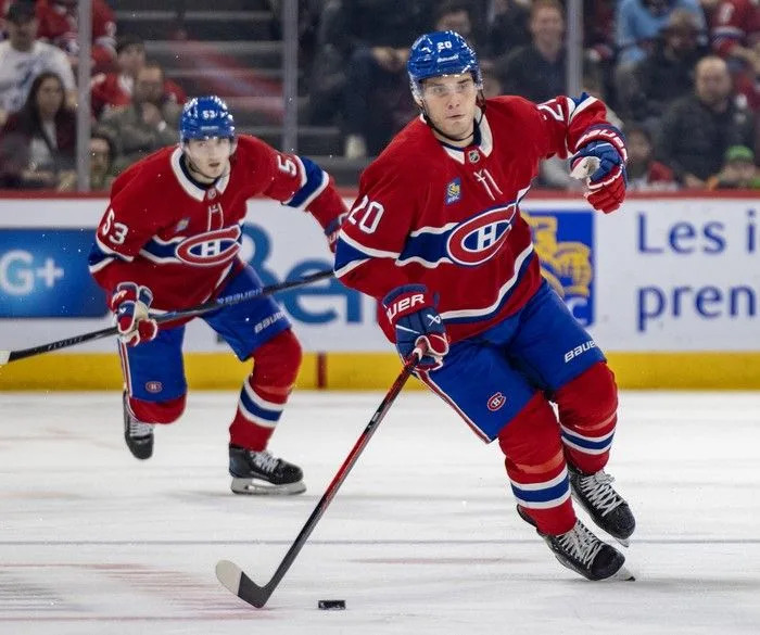  Canadiens winner Juraj Slafkovsky carries the puck out of the defensive zone ahead of defenceman Noah Dobson during third period against the Vancouver Canucks in Montreal on Jan. 12.