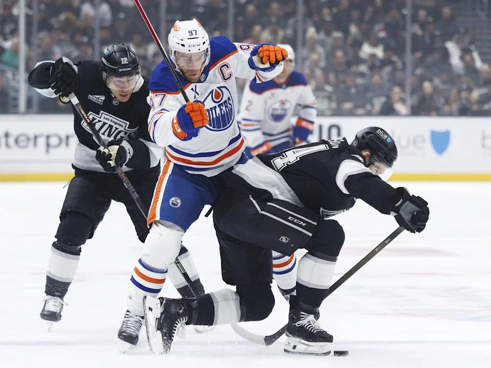  Trevor Moore #12 of the Los Angeles Kings and Mikey Anderson #44 of the Los Angeles Kings defend against Connor McDavid #97 of the Edmonton Oilers during the first at Crypto.com Arena on Feb. 26, 2026, in Los Angeles