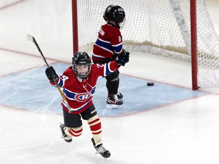  Phillip-Édouard Danault strikes a familiar pose as he and Hudson Matheson take shots on the net while their fathers compete in the Montreal Canadiens’ skills competition at the Bell Centre on Sunday, February 22, 2026.